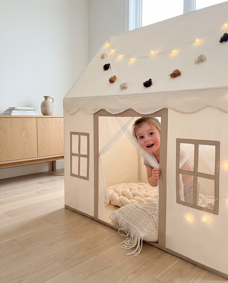 Real photo: child peeking out of the play tent doorway