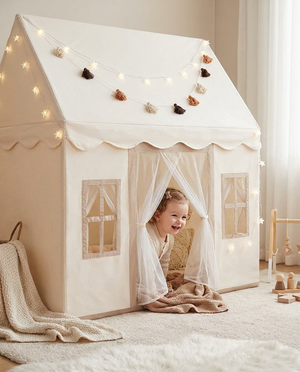 Toddler peeking out of the play tent
